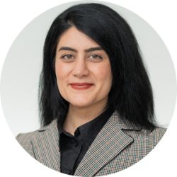 Dr Skylar Izadi, Podiatrist Headshot, wearing black button up and grey plaid blazer